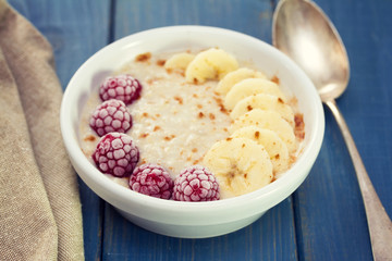 oatmeal with banana and berries on white dish