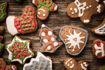 Colorfully Christmas cookies on rustic wooden background