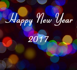 Card with Happy New Year 2017 writing on multicolor light bokeh. New Year 2017 card.