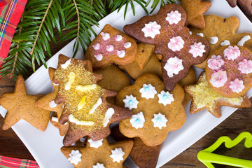 Colorful Christmas gingerbread cookies on wooden background