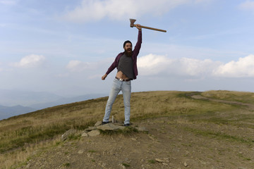 Fototapeta premium bearded man with ax on mountain