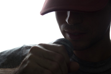 Young man in cap singing into a microphone