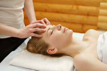Obraz na płótnie Canvas Caring about beauty. Facial massage in spa salon