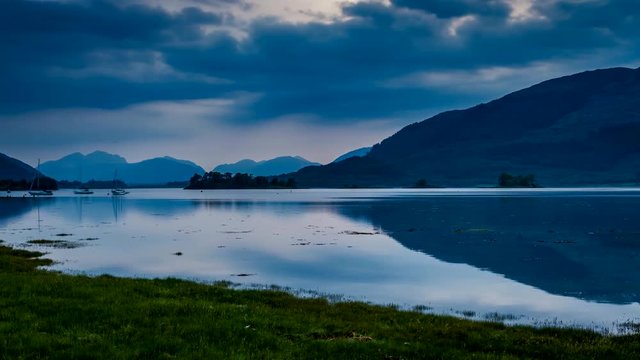 Sunset over the bay with boats in Scotland, 4k, timelapse
