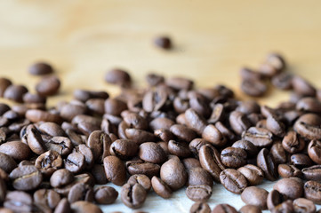 Fototapeta premium Roasted coffee beans on a wooden background