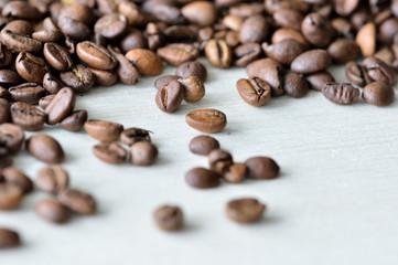 Roasted coffee beans on a wooden background