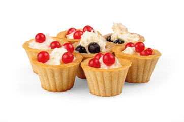 healthy breakfast. whipped cream yogurt, blueberries and viburnum berries, fresh crispy tartlet. focus at central point on white background