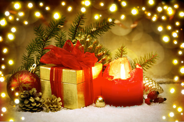 Advent candle and golden gift box.