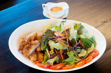 Breaded chicken with salad ,soft focus