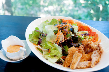 Breaded chicken with salad ,soft focus