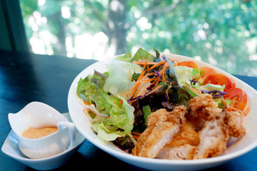 Breaded chicken with salad ,soft focus