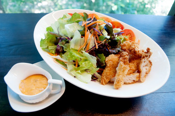Breaded chicken with salad ,soft focus