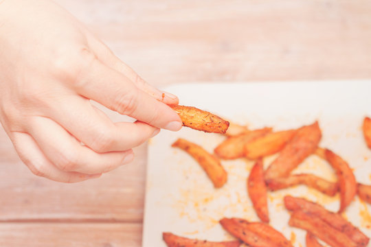 Female Hand Reaching For French Fries