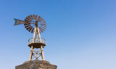 Wooden mill with rusty shovel - body text space
