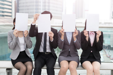 businesspeople with billboard in office