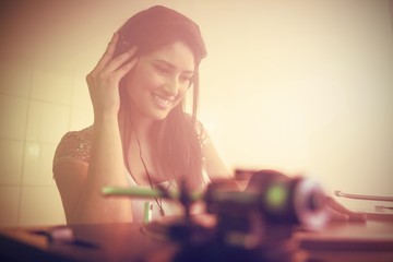 Pretty female DJ playing music