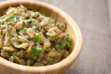 Baba ganoush in bowl on wooden table

