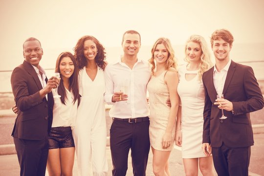 Portrait Of Well Dressed People Posing Next To Limousine