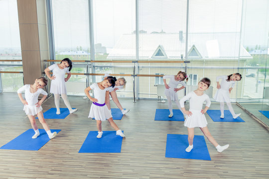 Girls doing gymnastic exercises or exercising in fitness class