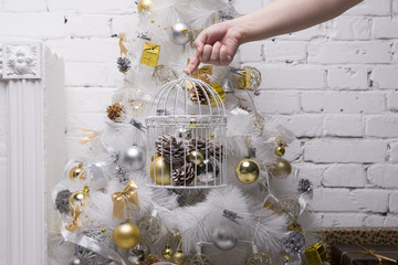 White Christmas tree with golden and silver balls, gift boxes, holiday decorations