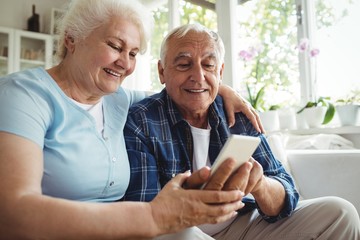 Senior couple using mobile phone