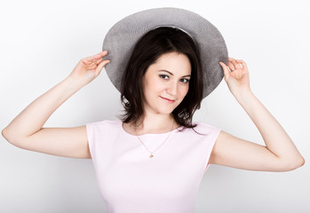 beautiful young brunette woman holding a broad-brimmed hat, she expression of different emotions