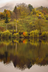 landscape with reflections of autumn colors on a lake