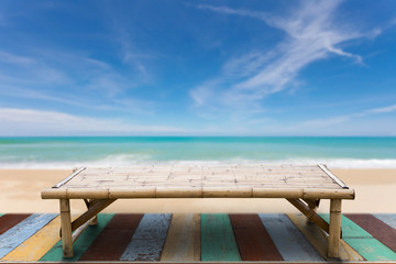 Wooden bamboo sunbeds on old wood ,beautiful beach and sea