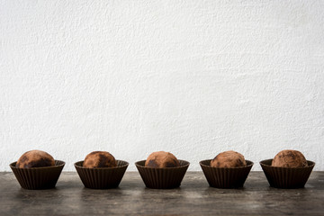 Homemade chocolate truffles on wooden table


