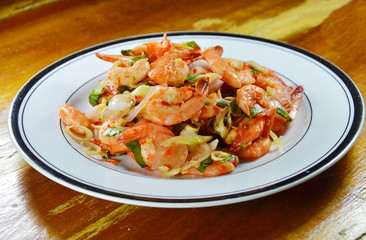spicy shrimp with herb salad on dish