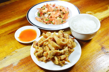 rice porridge eat with fried chicken and spicy shrimp salad