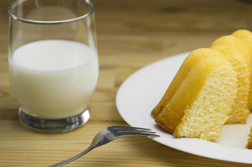 Blick auf einen hausgemachten Zitronenkuchen mit einem  Glas frischer Milch