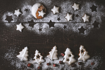 Winter forest made by cookies on the wooden background top view
