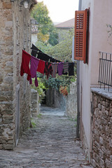 hanging laundry in narrow street