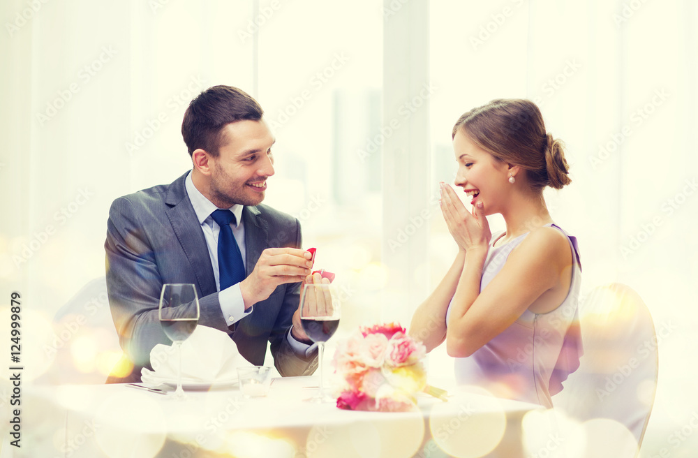 Wall mural man proposing to his girlfriend at restaurant