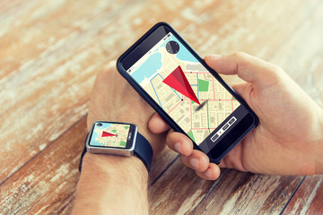 close up of hands with smart phone and watch