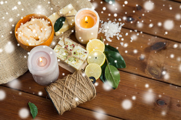 natural soap and body scrub with candles on wood