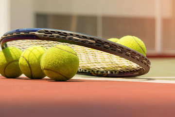 Tennis Ball with Racket on the clay tennis court