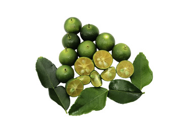 Cut limes and green leaves on white background.