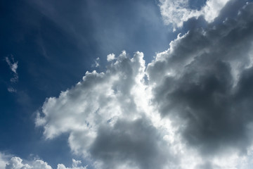 Blue sky with some white puffy clouds.