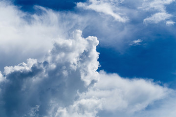 Blue sky with some white puffy clouds.
