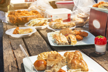 types of local turkish pastry on wooden picnic table and a salt shaker in frame