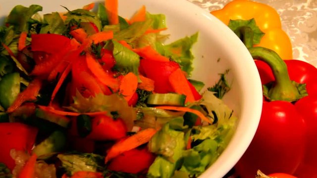 Vegetable Salad in a White Porcelain Bowl and Two Sweet Peppers