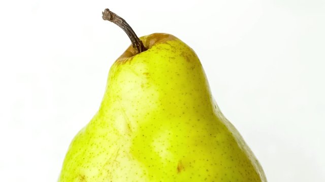 Closeup of fresh green pear with tap water washing over it, includes sound