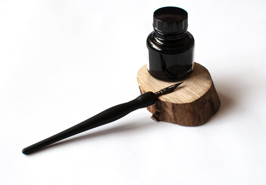 old ink pen and ink bottle isolated on white bakground