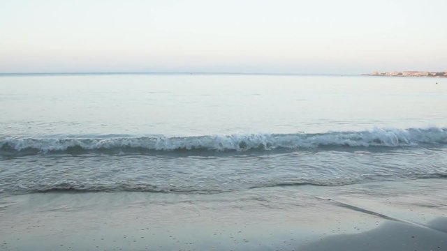 the calm blue sea waves lapping on the shoreline