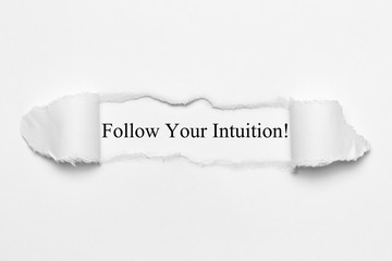 Follow Your Intuition! on white torn paper
