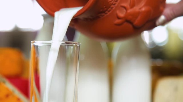 pour the milk into cup from jug, closeup