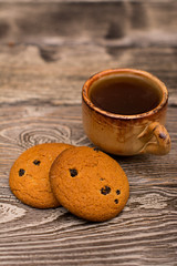 Small cup of coffee, cookies on wooden background
