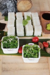 Making sushi roll and seaweed salad with rice.